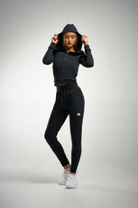 Lady in black joggers and hoodie
